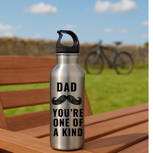 Dad you are one of a kind stainless steel hooked lid water bottle on a picnic bench with grass, blue sky and wall behind